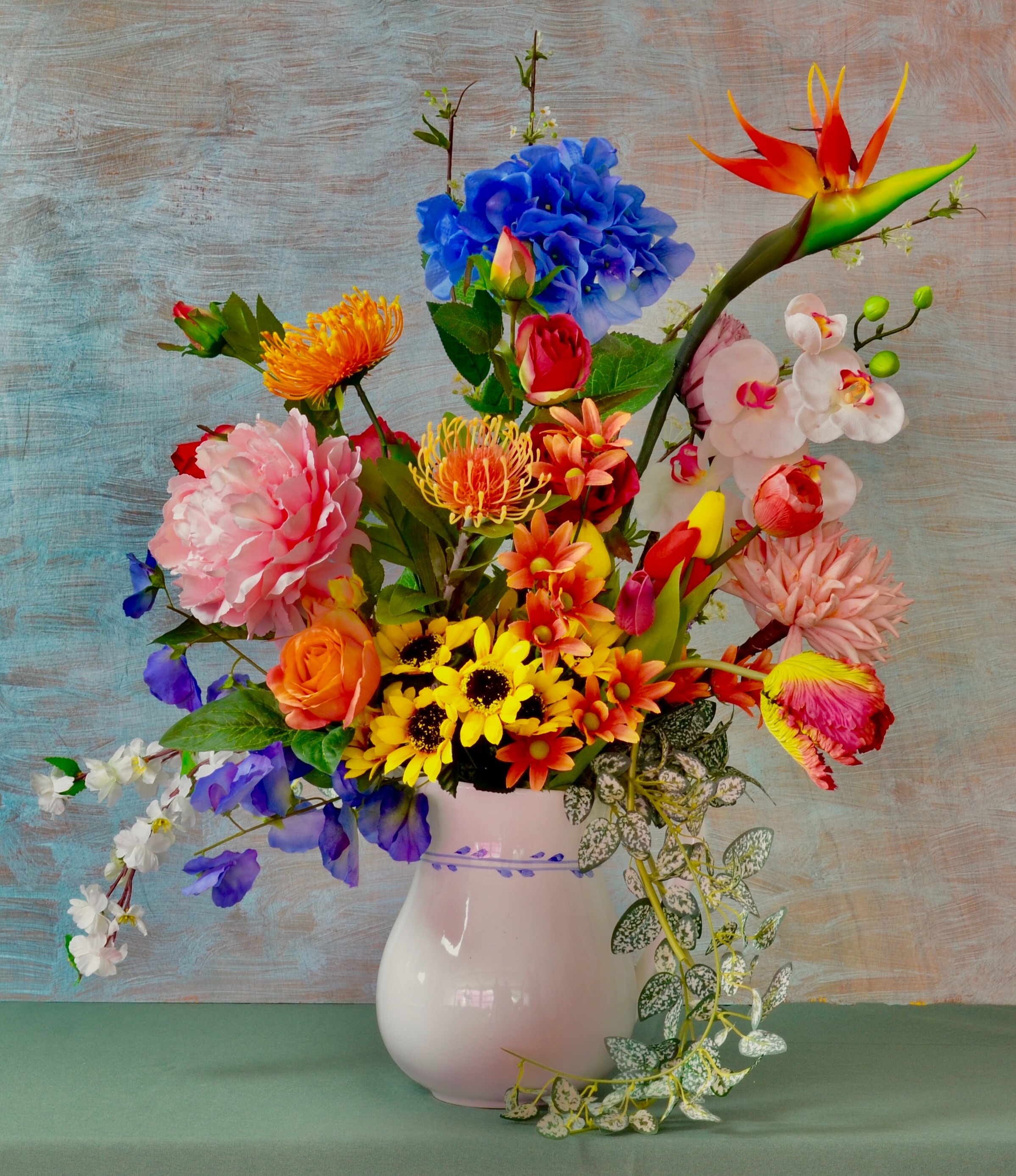 Picture of a bouquet of multi-coloured flowers in a vase